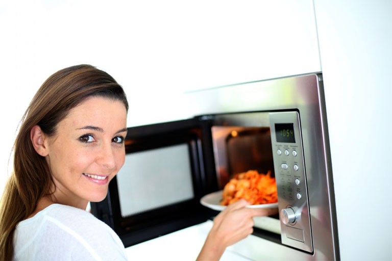 woman cooking food with oven